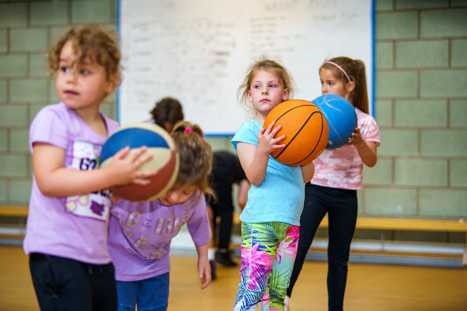 children at kids camp holding basket balls