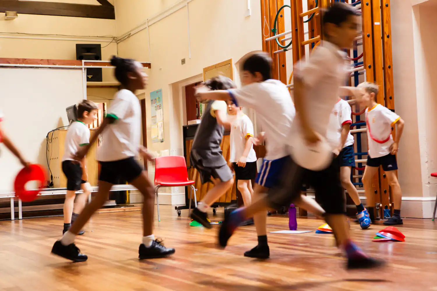 Group of children running in large indoor space